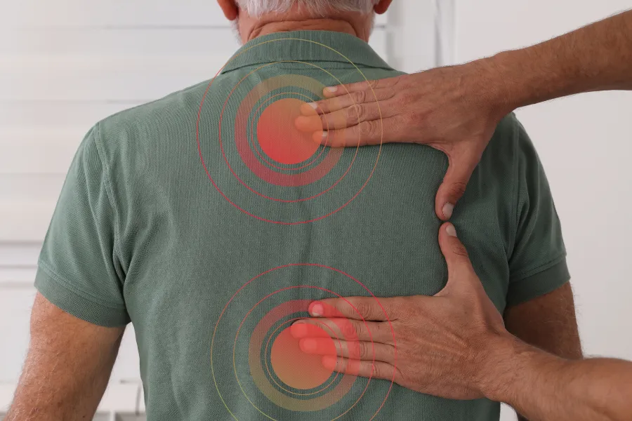 hands on mans back red circles around fingers